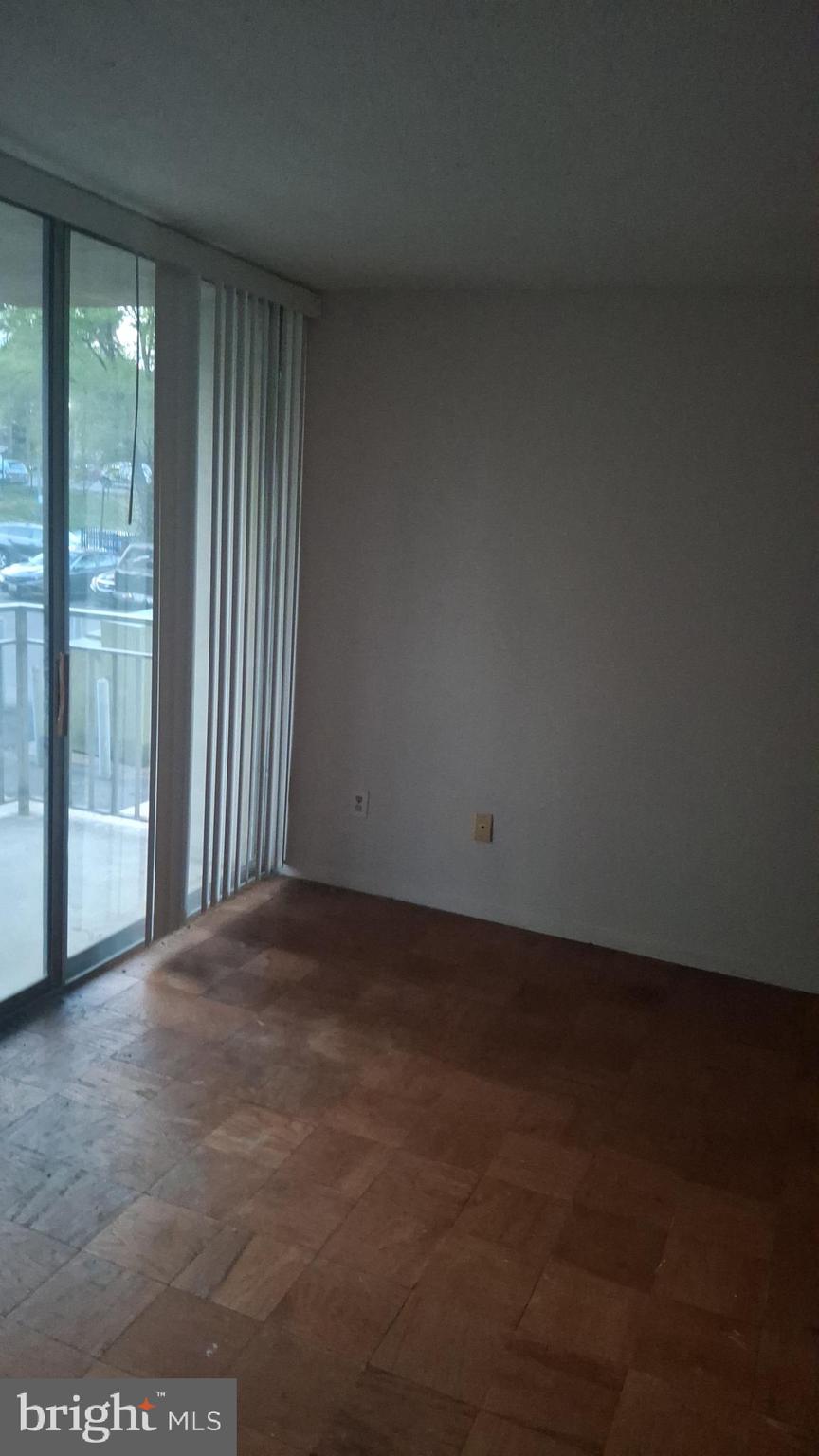 1836 Metzerott Road, Unit 222 Hyattsville, MD 20783 - Photo 5 of 9 an empty room with wooden floor and windows