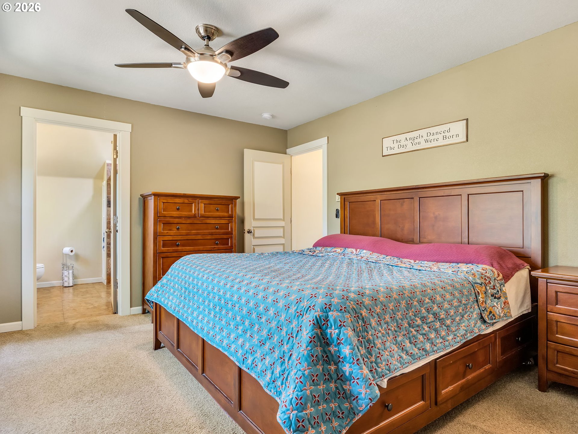 1077 Southwest Ridge Road Warrenton, OR 97146 - Photo 32 of 46 a bedroom with a bed and a chandelier