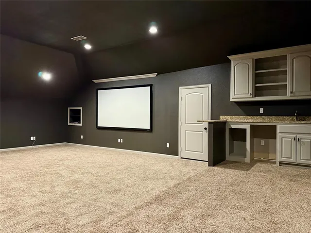 a view of an empty room with a kitchen