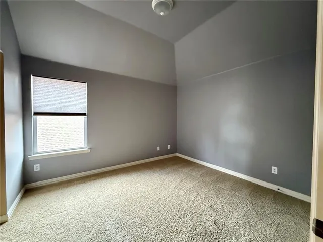 a view of a house with a yard and pathway