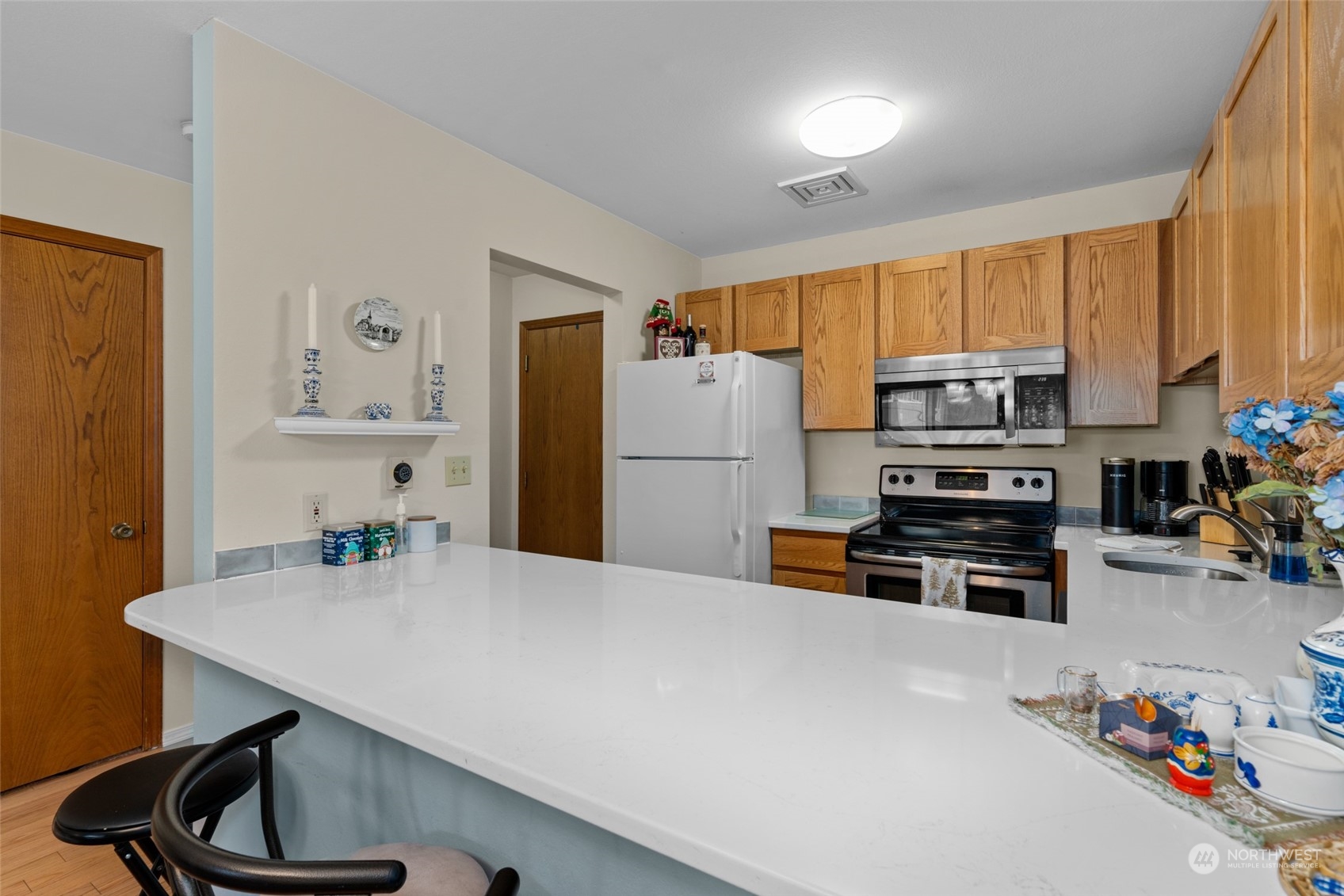 325 Division Street, Unit C Leavenworth, WA 98826 - Photo 11 of 25 a kitchen with a refrigerator a stove a sink cabinets and a dining table