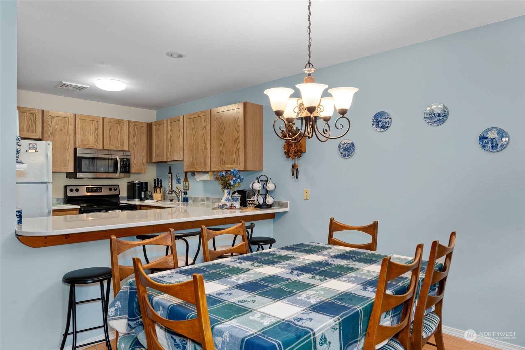325 Division Street, Unit C Leavenworth, WA 98826 - Photo 12 of 25 a dining room filled chandelier and kitchen view