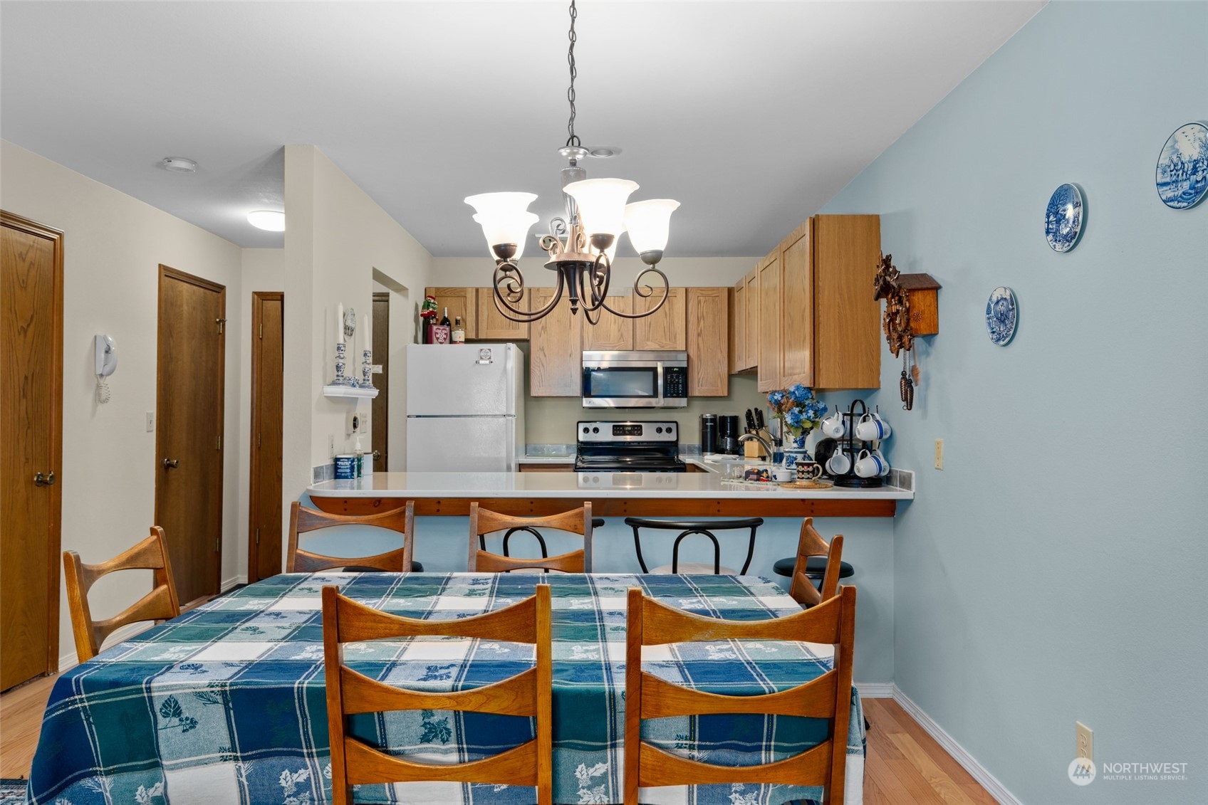325 Division Street, Unit C Leavenworth, WA 98826 - Photo 13 of 25 a view of a dining room with furniture a chandelier and wooden floor