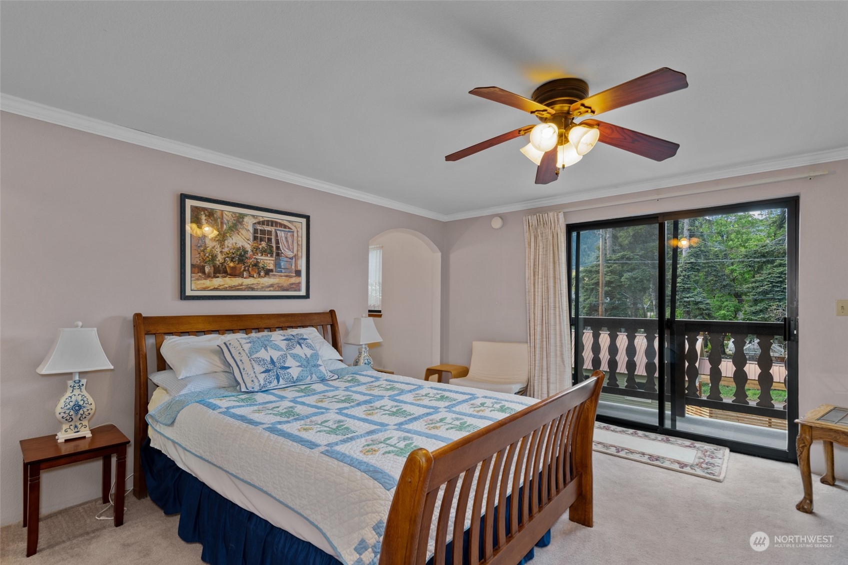 325 Division Street, Unit C Leavenworth, WA 98826 - Photo 17 of 25 a bedroom with a bed and a chandelier