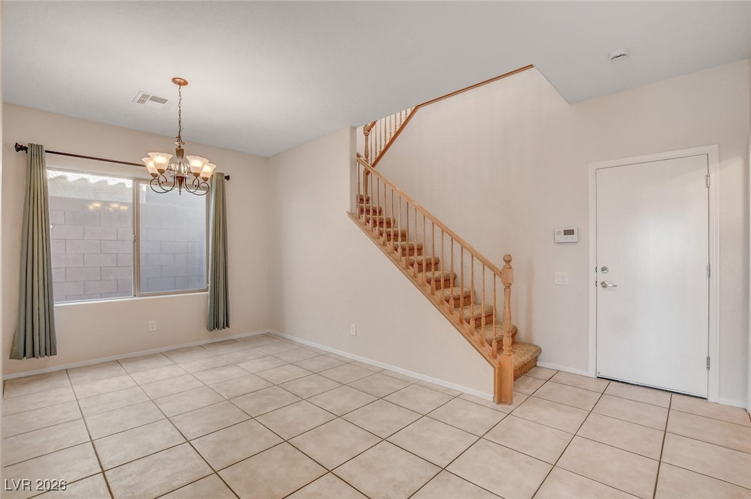 2460 Rue Bienville Way Henderson, NV 89044 - Photo 18 of 50 Entrance foyer featuring a chandelier, stairway, and light tile patterned floors