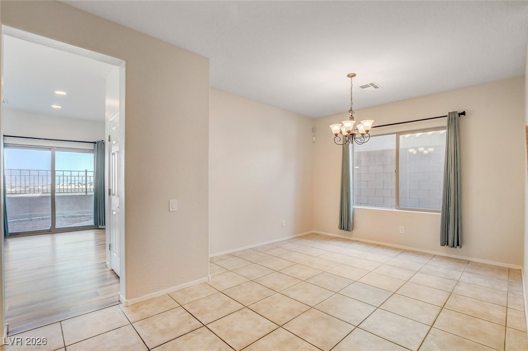 2460 Rue Bienville Way Henderson, NV 89044 - Photo 19 of 50 Unfurnished room featuring a chandelier and light tile patterned flooring