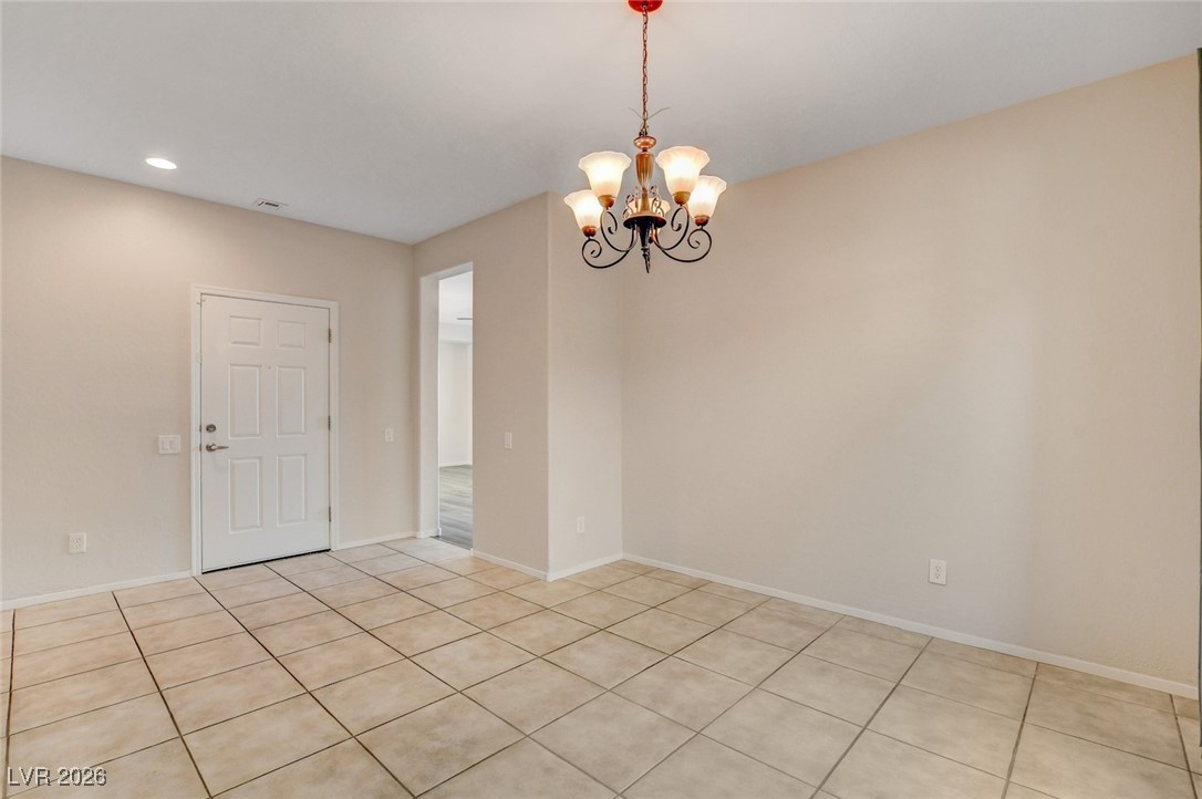 2460 Rue Bienville Way Henderson, NV 89044 - Photo 20 of 50 Unfurnished room featuring a chandelier, light tile patterned floors, and recessed lighting