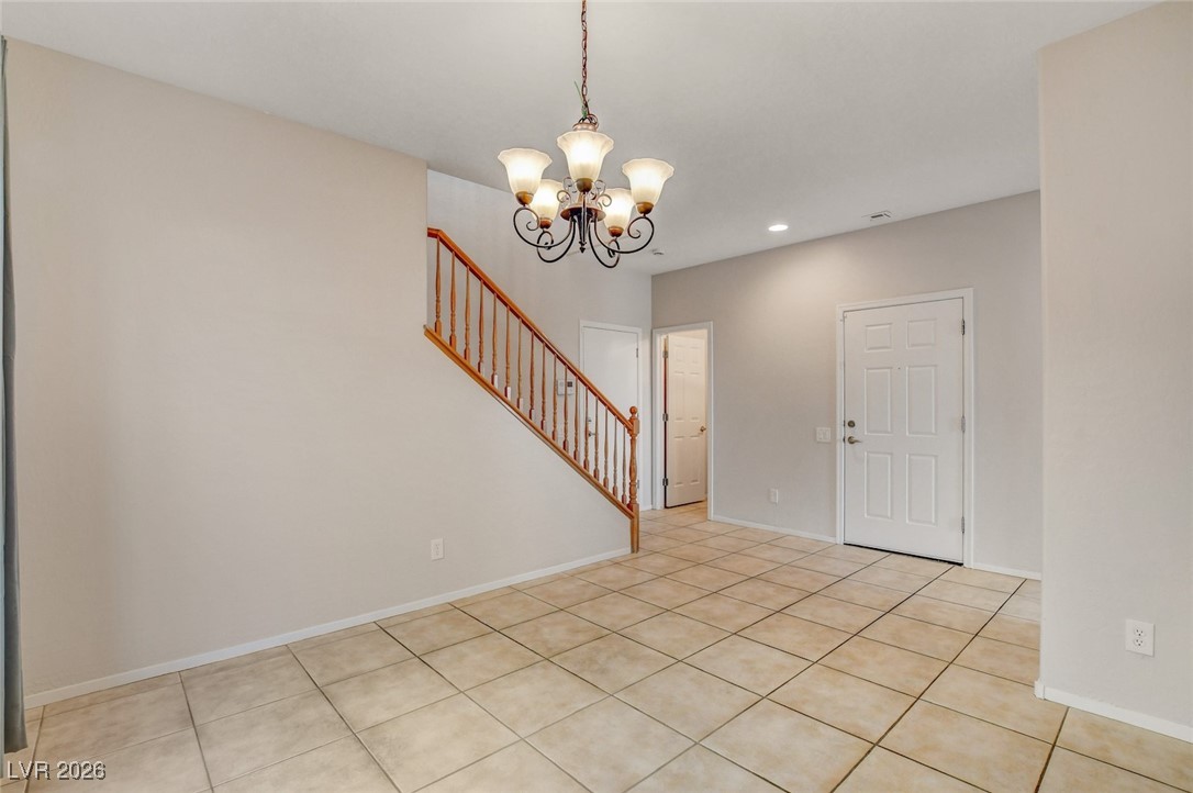 2460 Rue Bienville Way Henderson, NV 89044 - Photo 21 of 50 Entrance foyer with a chandelier, stairs, light tile patterned floors, and recessed lighting