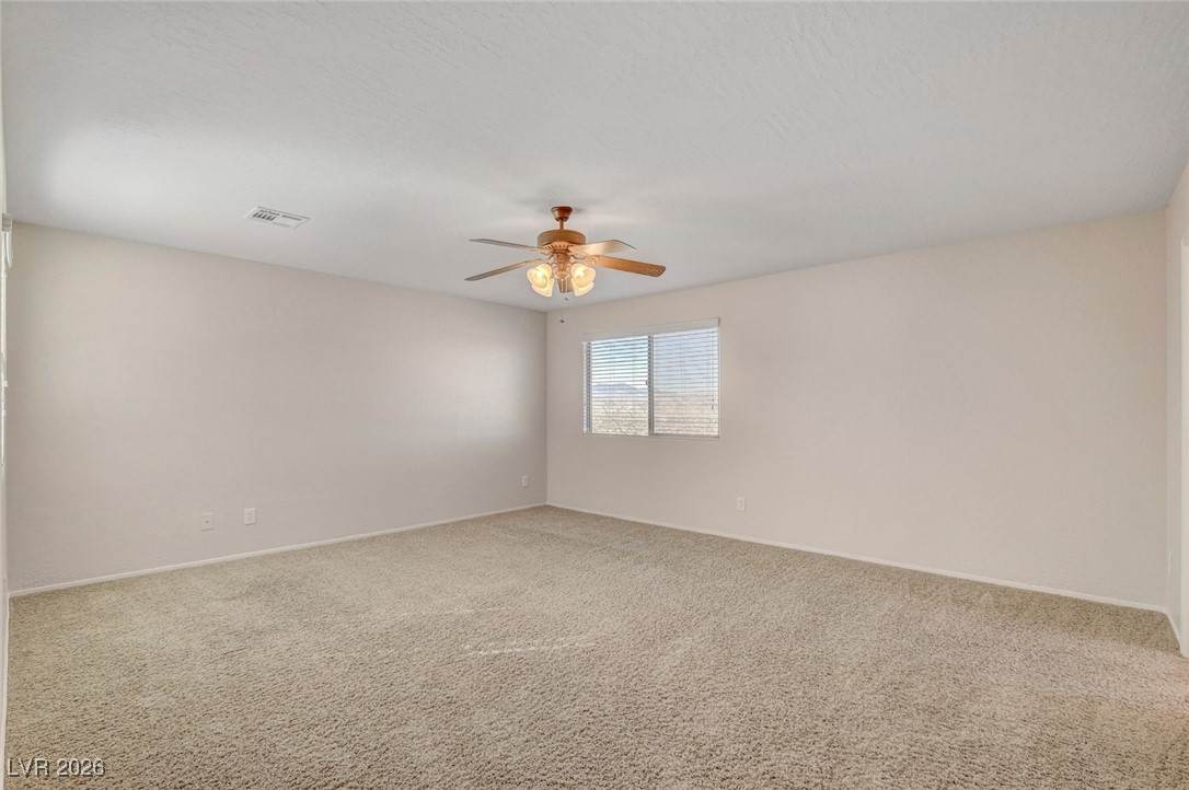 2460 Rue Bienville Way Henderson, NV 89044 - Photo 29 of 50 Carpeted empty room with baseboards and ceiling fan