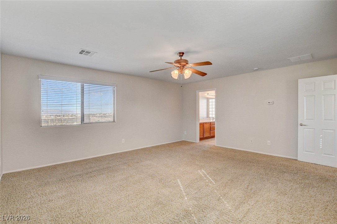 2460 Rue Bienville Way Henderson, NV 89044 - Photo 30 of 50 Empty room featuring light carpet and a ceiling fan
