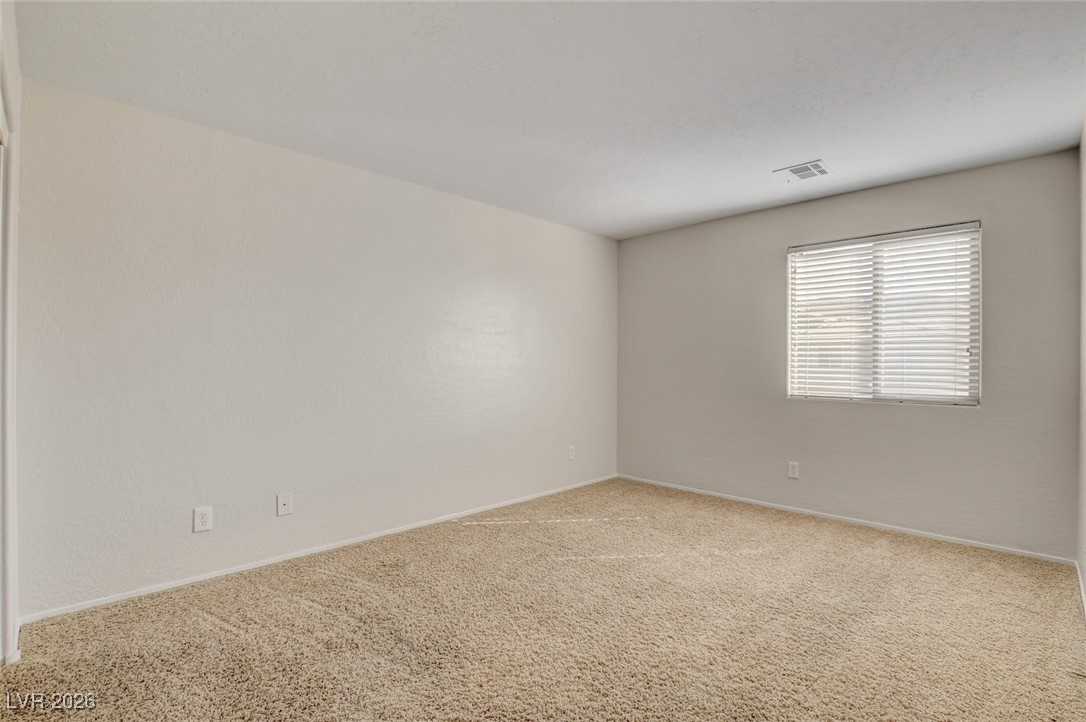 2460 Rue Bienville Way Henderson, NV 89044 - Photo 37 of 50 Carpeted spare room featuring baseboards