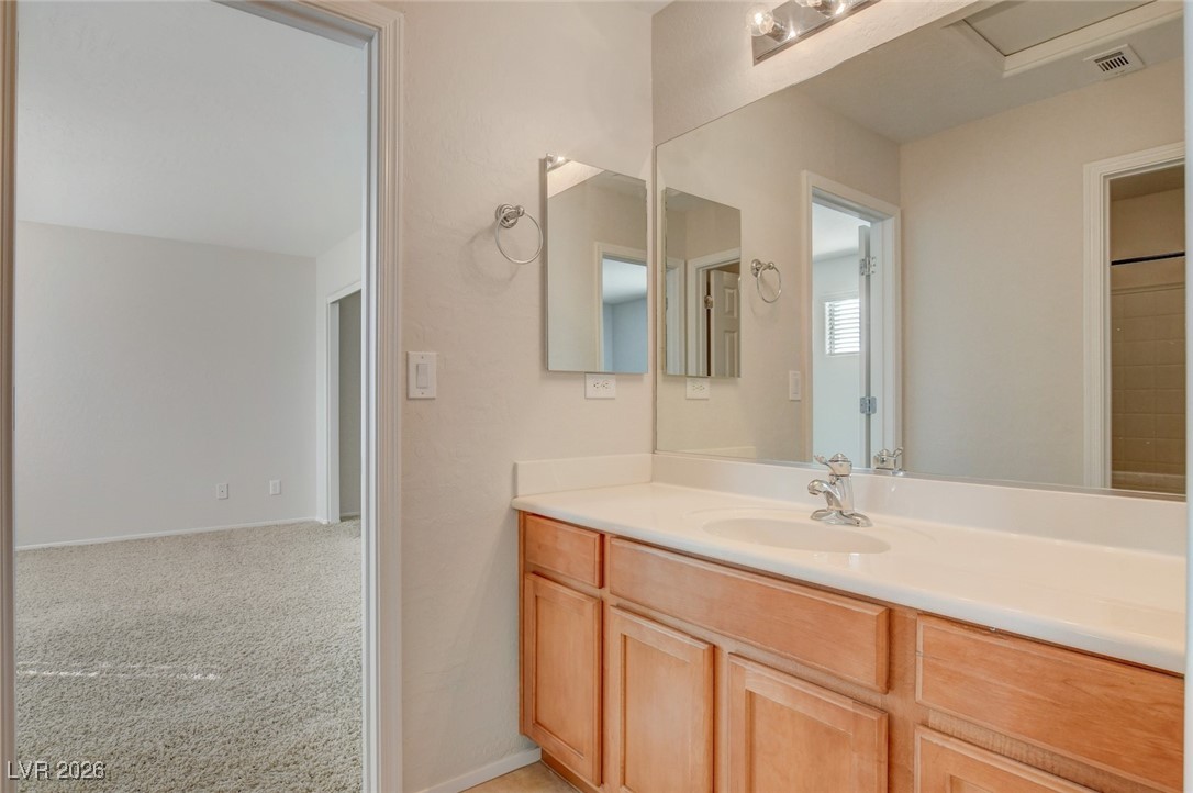 2460 Rue Bienville Way Henderson, NV 89044 - Photo 41 of 50 Full bathroom with vanity and light carpet