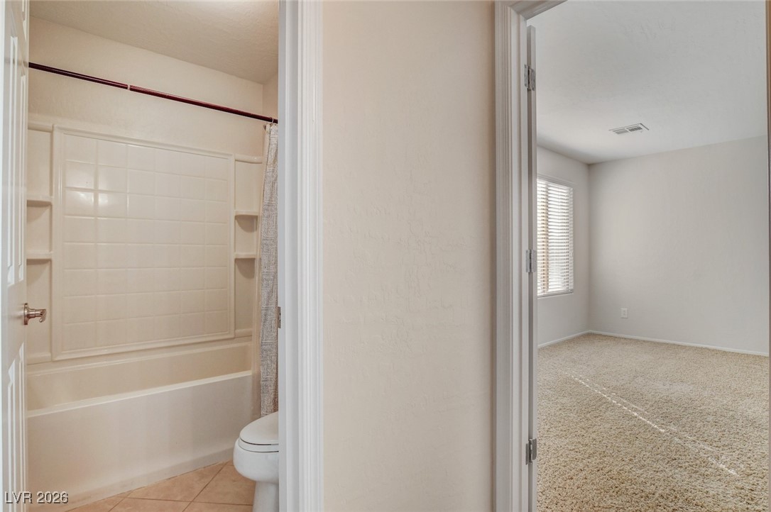 2460 Rue Bienville Way Henderson, NV 89044 - Photo 42 of 50 Full bathroom featuring toilet and shower / tub combo with curtain