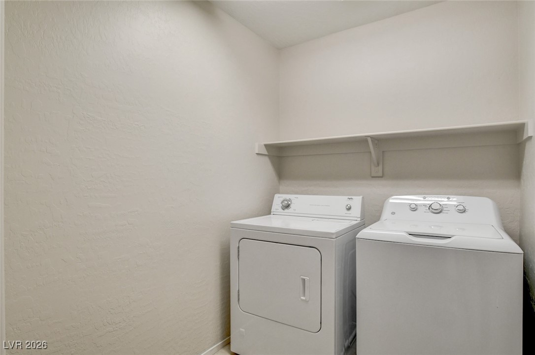 2460 Rue Bienville Way Henderson, NV 89044 - Photo 44 of 50 Washroom with washing machine and clothes dryer and a textured wall