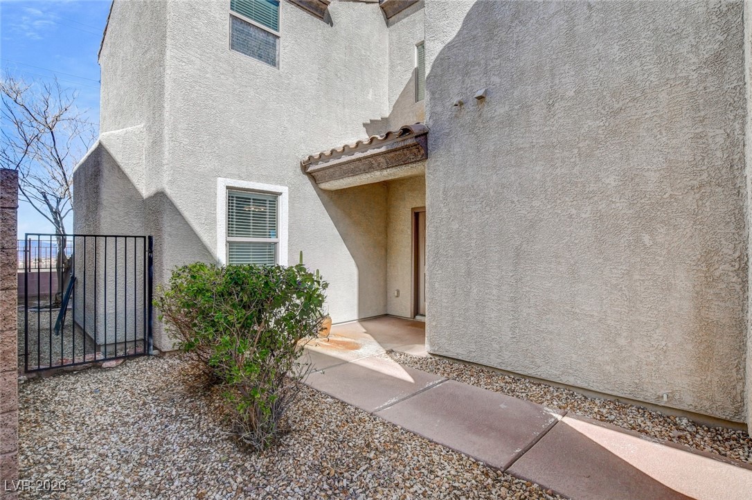 2460 Rue Bienville Way Henderson, NV 89044 - Photo 6 of 50 Doorway to property featuring a gate and stucco siding