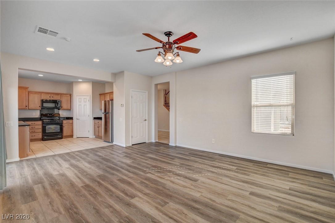 2460 Rue Bienville Way Henderson, NV 89044 - Photo 8 of 50 Unfurnished living room featuring ceiling fan, light wood-type flooring, and recessed lighting
