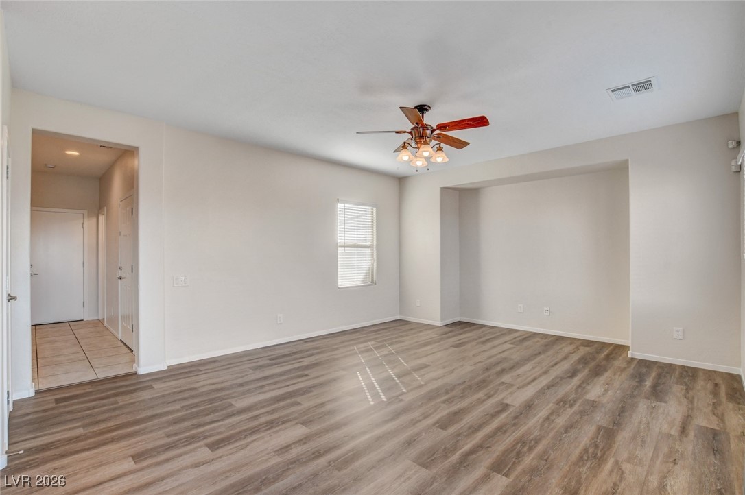 2460 Rue Bienville Way Henderson, NV 89044 - Photo 10 of 50 Unfurnished room with light wood finished floors and a ceiling fan