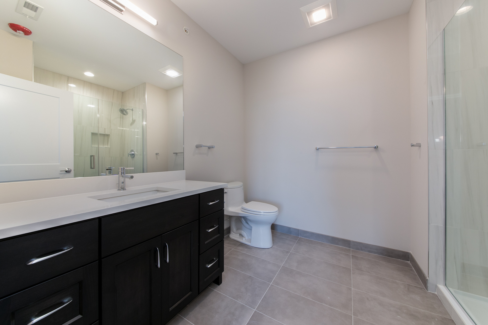 1116 Courtland Avenue, Unit 304 Park Ridge, IL 60068 - Photo 12 of 19 a bathroom with a granite countertop sink a toilet and a mirror