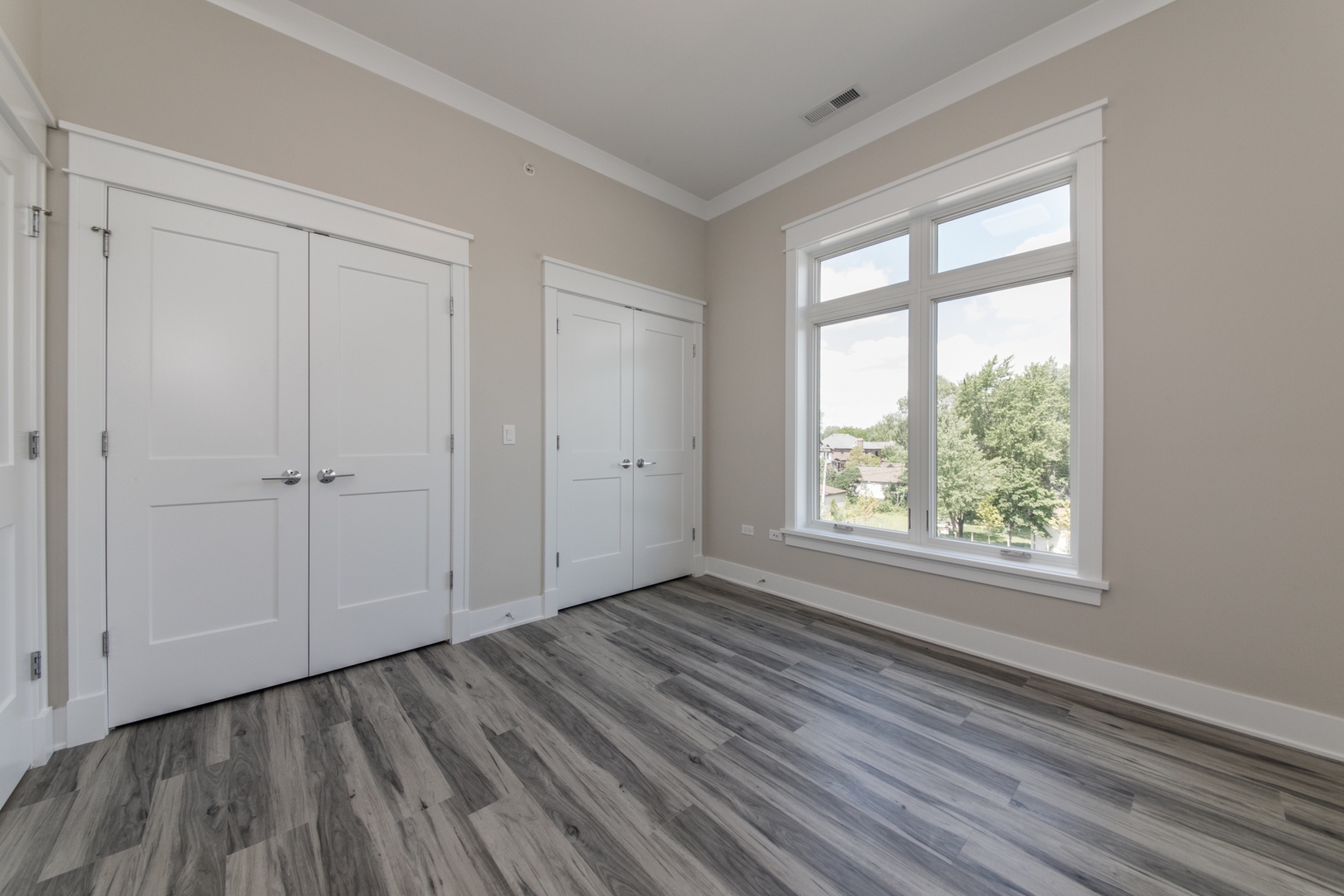 1116 Courtland Avenue, Unit 304 Park Ridge, IL 60068 - Photo 17 of 19 a view of an empty room with wooden floor and a window