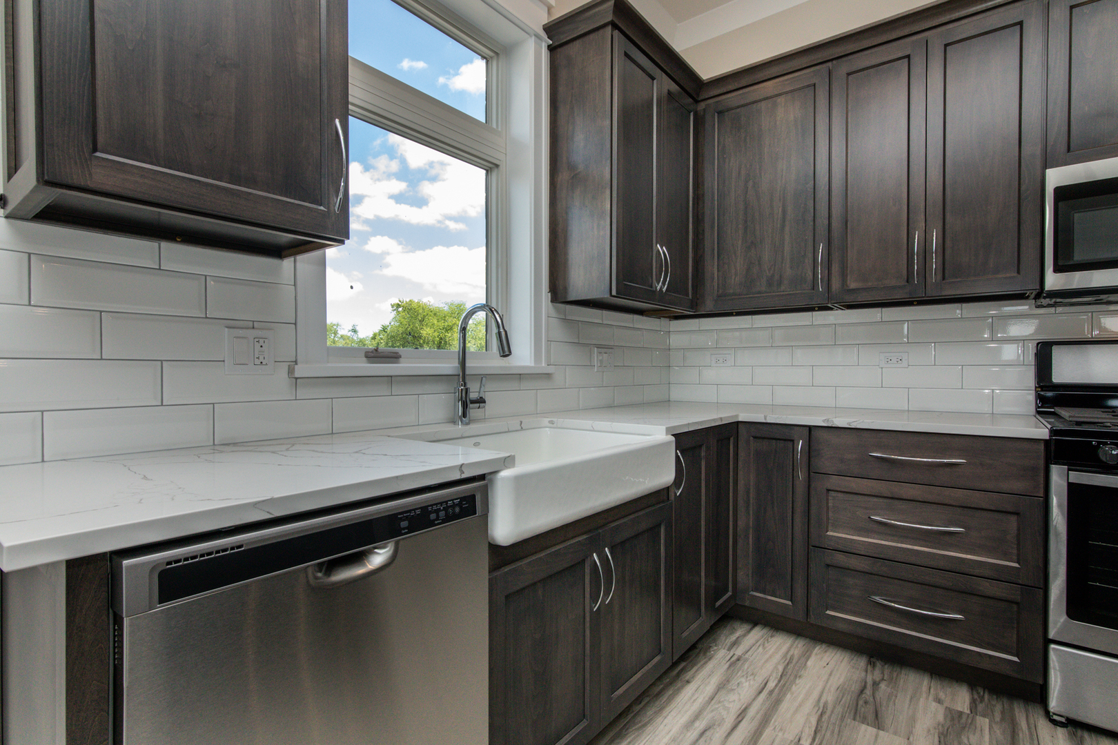 1116 Courtland Avenue, Unit 304 Park Ridge, IL 60068 - Photo 4 of 19 a kitchen with a sink stainless steel appliances wooden floor and a window