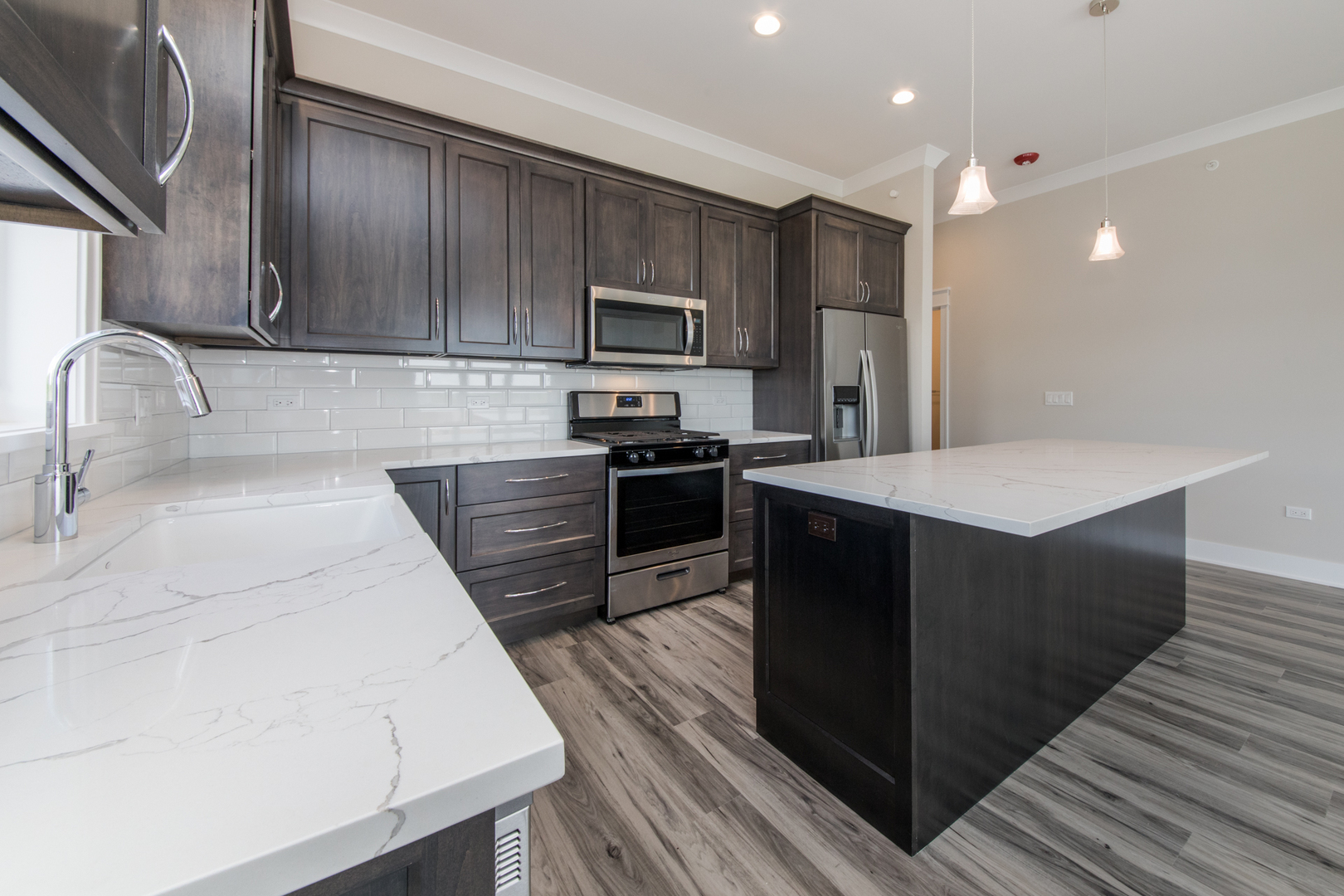 1116 Courtland Avenue, Unit 304 Park Ridge, IL 60068 - Photo 7 of 19 a kitchen with stainless steel appliances wooden cabinets a refrigerator and a stove top oven