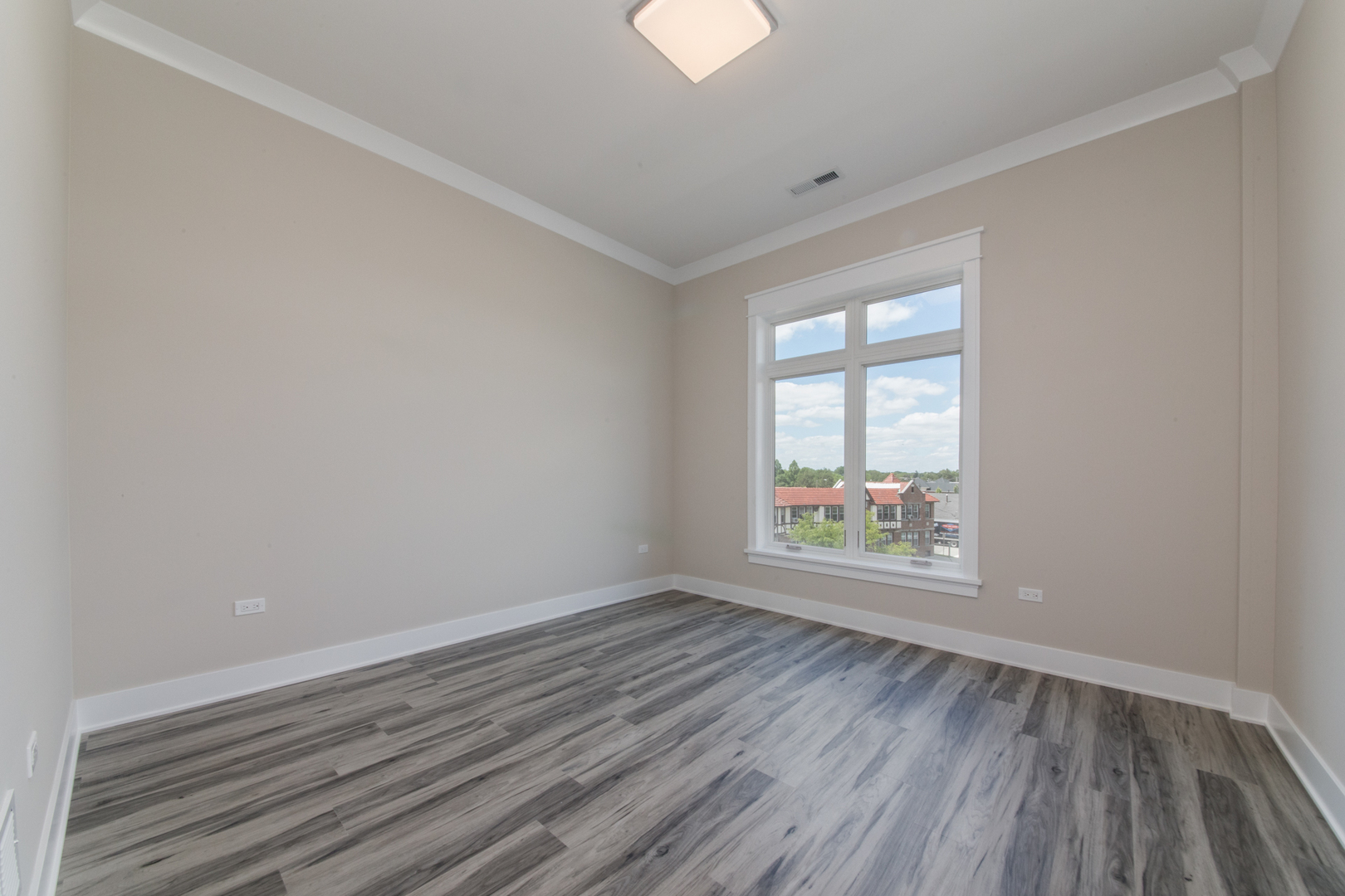 1116 Courtland Avenue, Unit 304 Park Ridge, IL 60068 - Photo 8 of 19 an empty room with wooden floor and windows