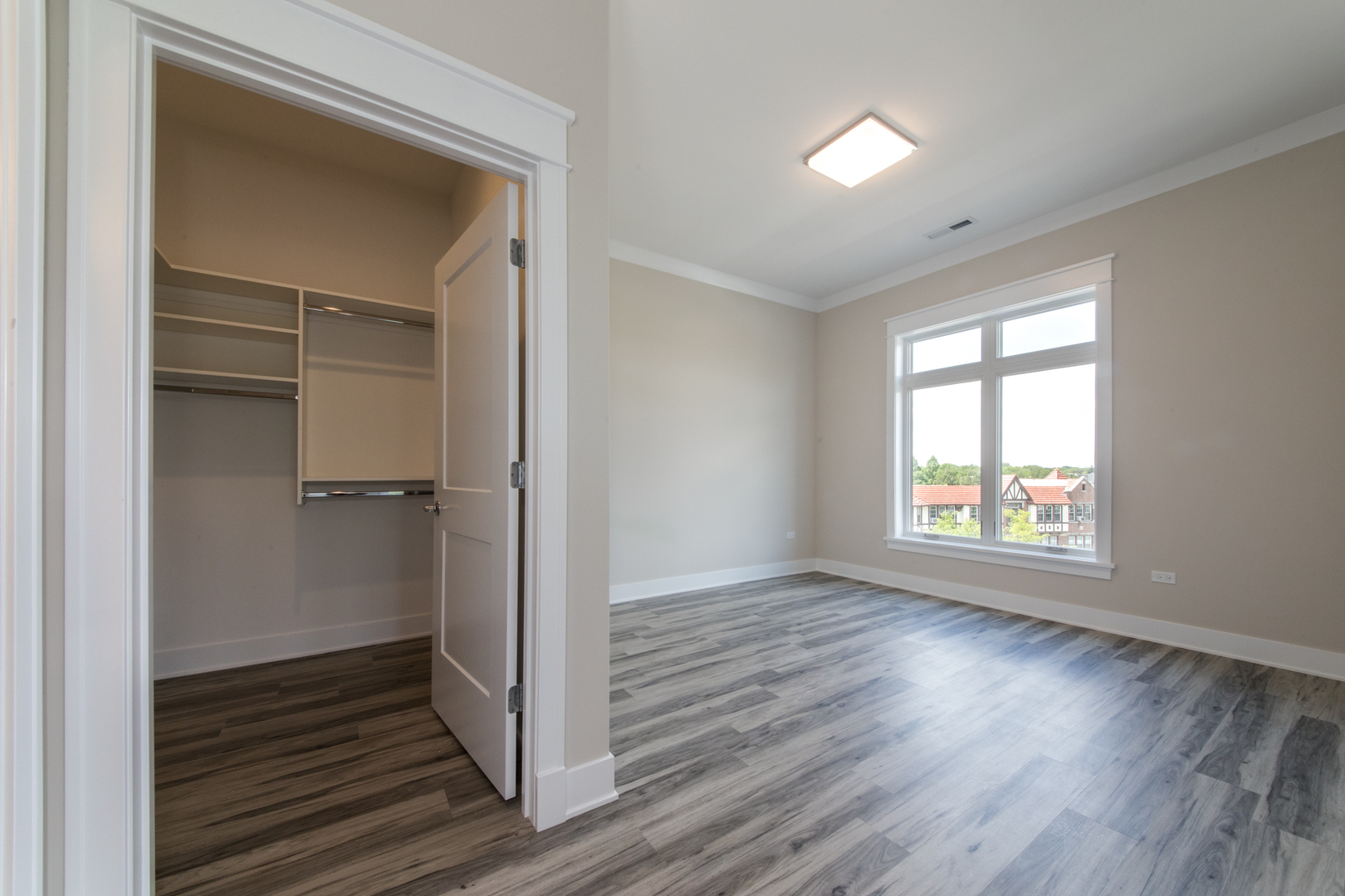 1116 Courtland Avenue, Unit 304 Park Ridge, IL 60068 - Photo 9 of 19 an empty room with wooden floor closet and windows