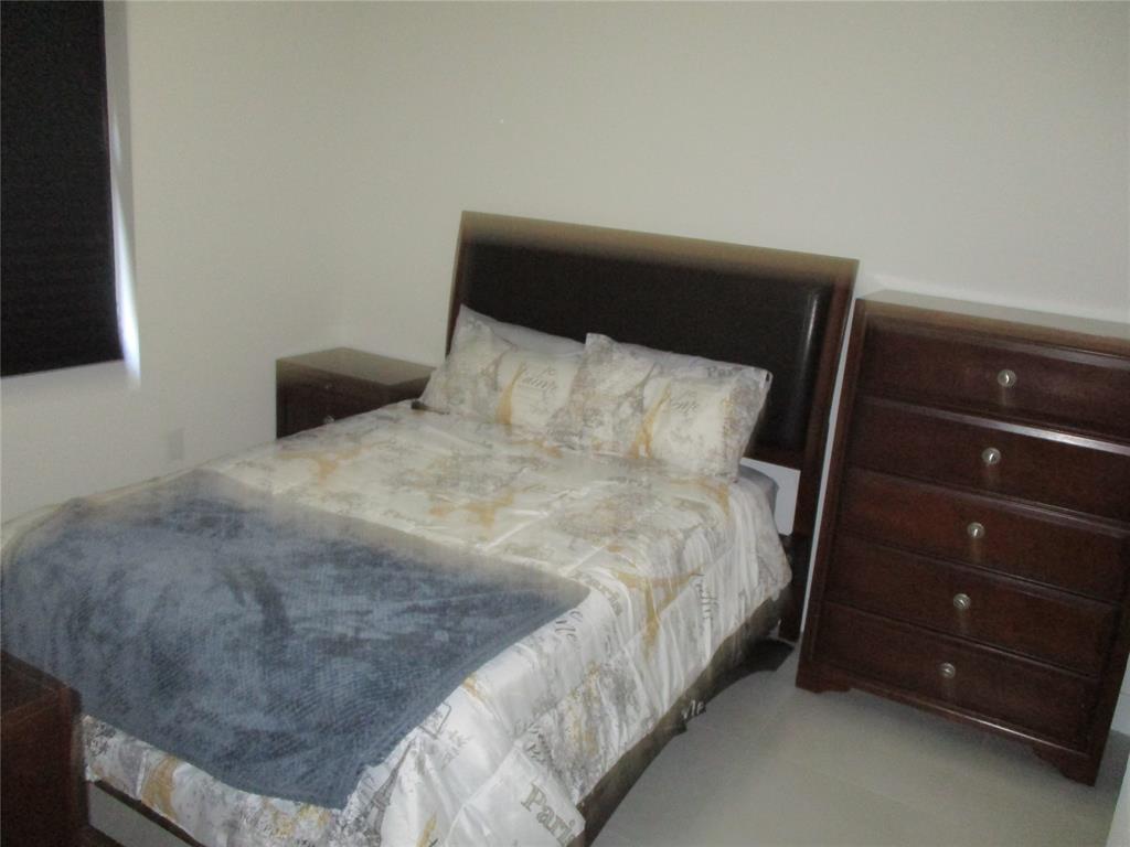 Undisclosed Address Homestead, FL 33030 - Photo 12 of 19 a bed sitting in a bedroom next to a window