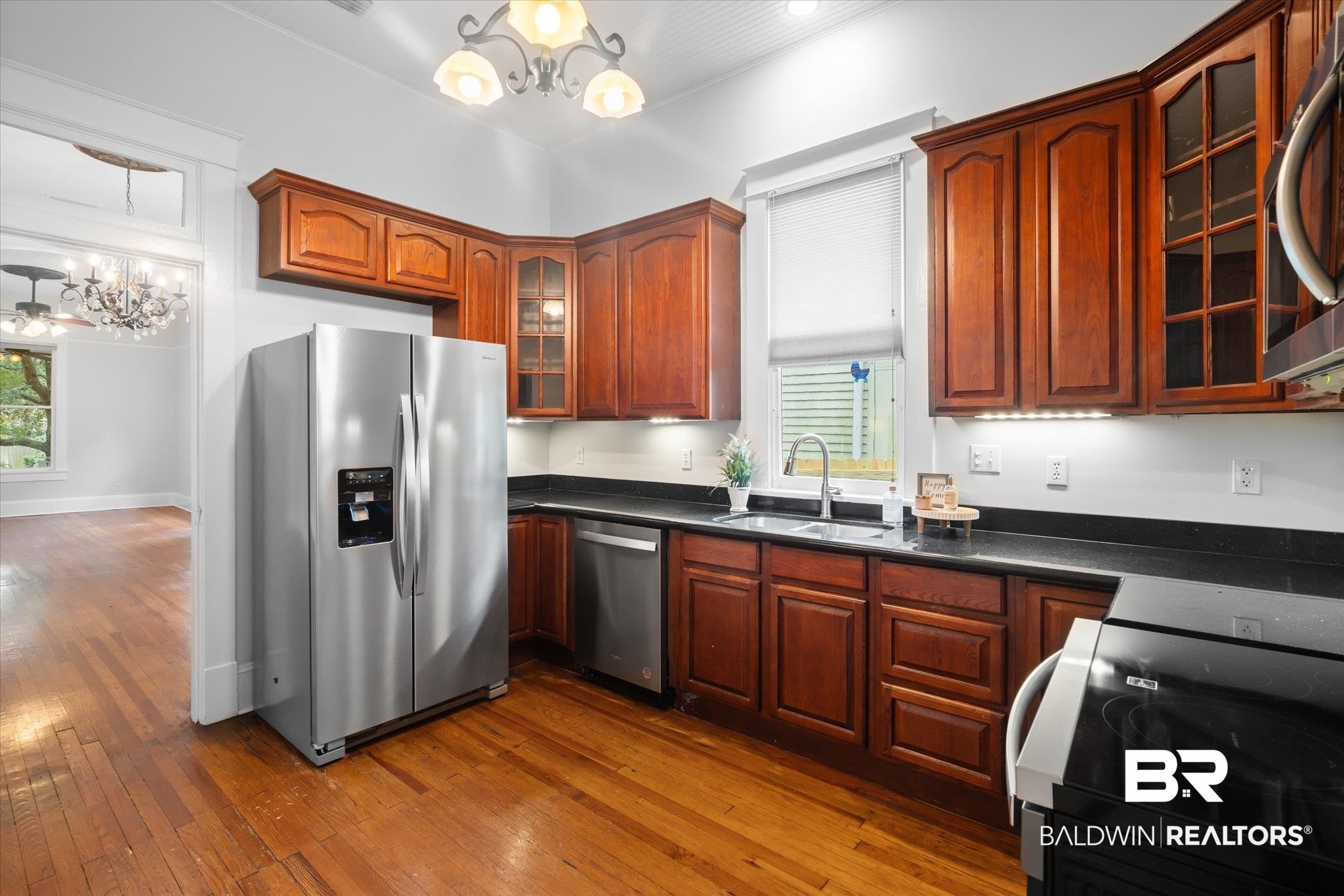 14 South Monterey Street Mobile, AL 36604 - Photo 8 of 41 Kitchen featuring sink, appliances with stainless steel finishes, dark hardwood / wood-style floors, hanging light fixtures, and a notable chandelier