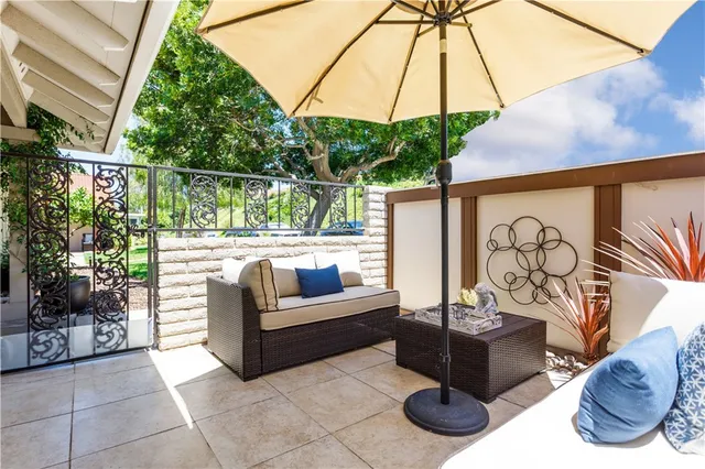 a glass door with couch and chairs