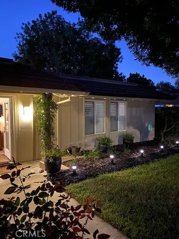 a view of a back yard of the house and a fountain