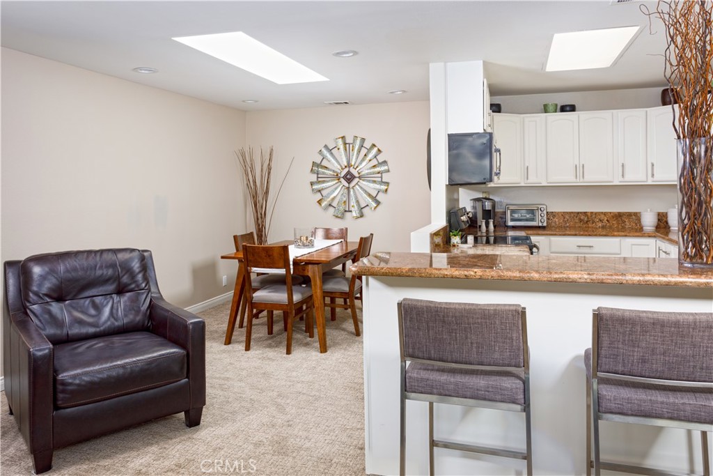 3103 Via Serena North, Unit A Laguna Woods, CA 92637 - Photo 3 of 17 a living room with furniture a sink and a refrigerator