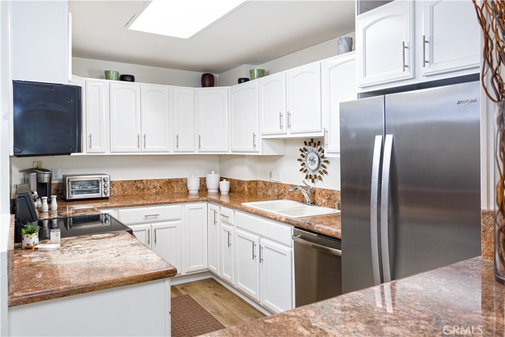 3103 Via Serena North, Unit A Laguna Woods, CA 92637 - Photo 6 of 17 a kitchen with a refrigerator stove and sink