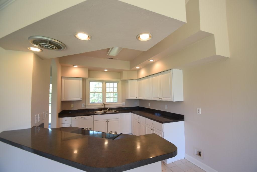 4027 Goodview Town Road Moneta, VA 24121 - Photo 4 of 21 a large kitchen with granite countertop a sink a window and stainless steel appliances
