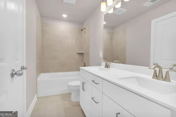 a bathroom with a sink a toilet a tub and a mirror