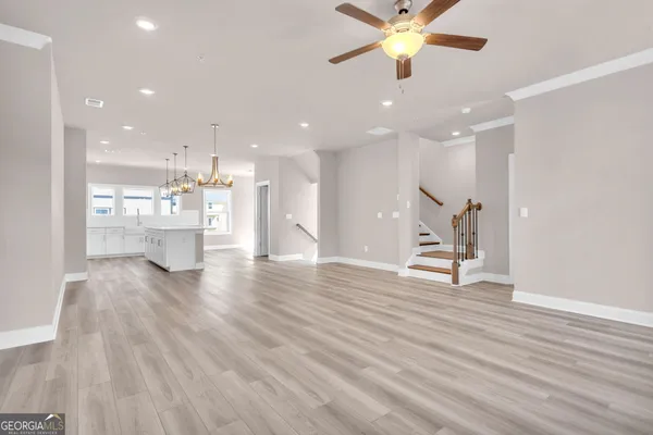 a view of an empty room with a kitchen