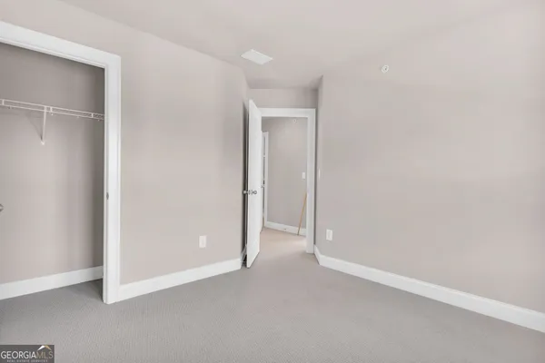 an empty room with closet area