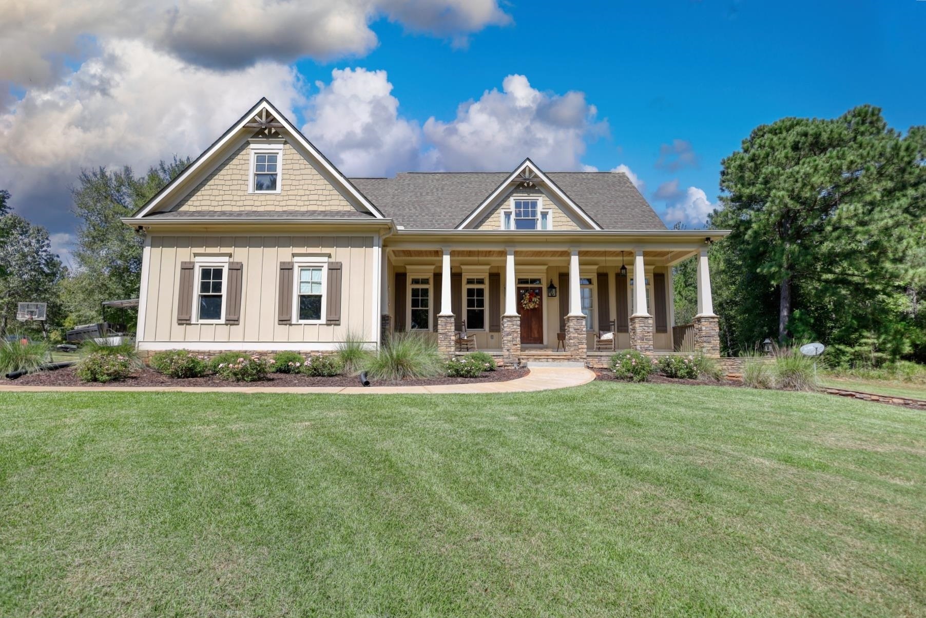 1051 Reese Lane Rutledge, GA 30663 - Photo 1 of 1 a front view of a house with a garden