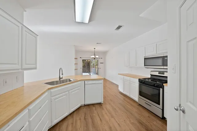 a kitchen with a sink stove and cabinets