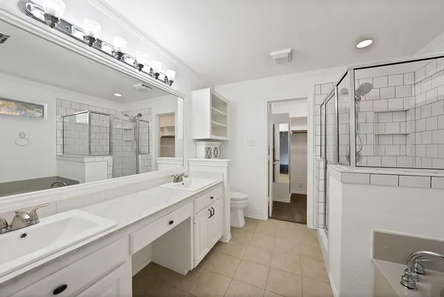 a spacious bathroom with a double vanity sink a large mirror and shower