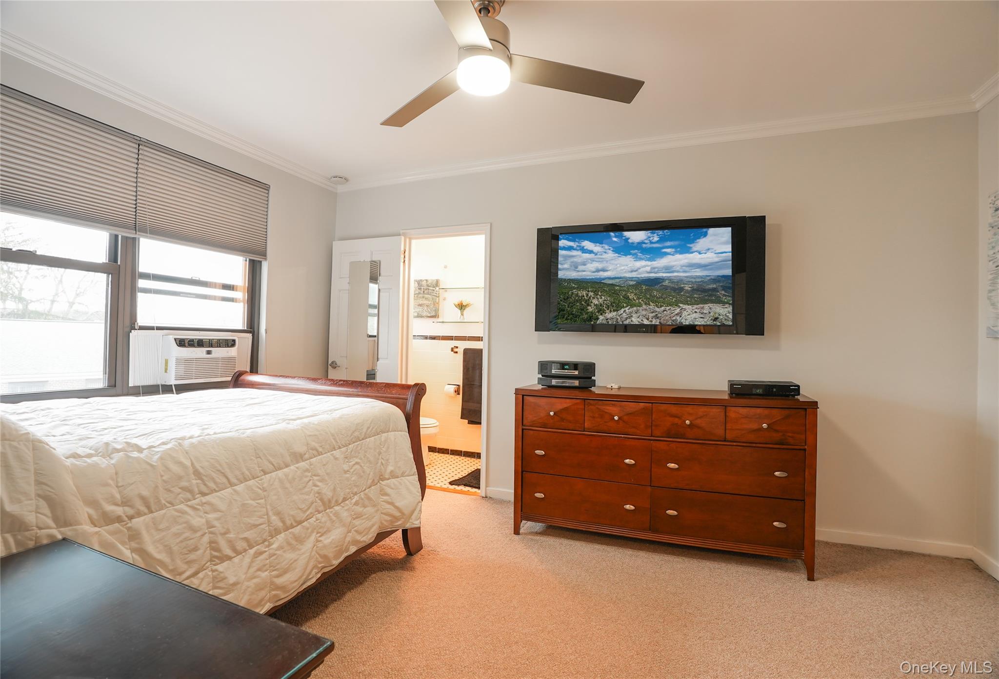 35 Rockledge Road, Unit 2A Hartsdale, NY 10530 - Photo 13 of 20 a spacious bedroom with a bed and a flat screen tv