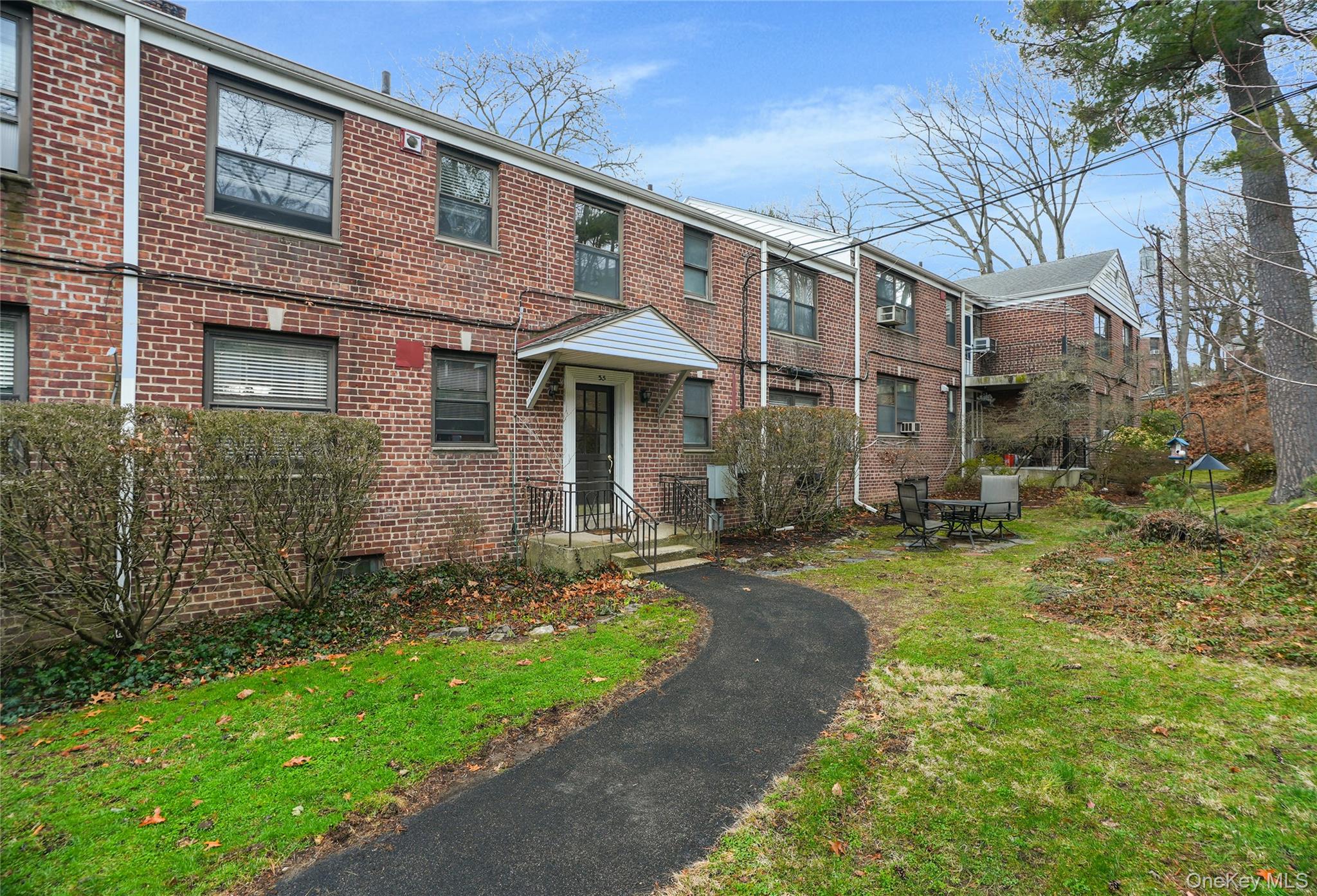 35 Rockledge Road, Unit 2A Hartsdale, NY 10530 - Photo 20 of 20 a front view of a house with garden