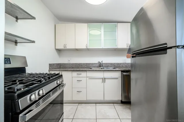 a kitchen with cabinets appliances and a window