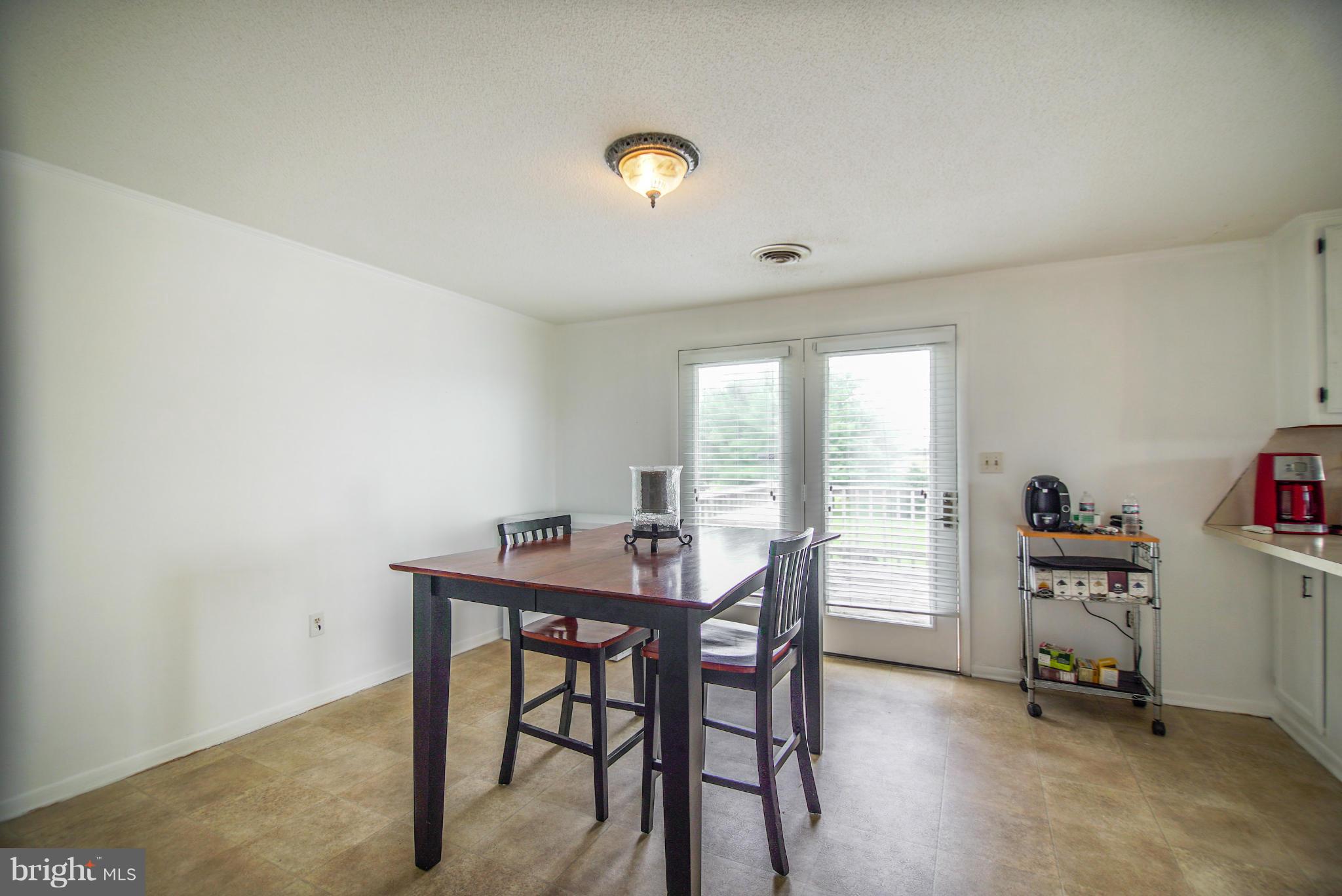 8025 Damascus Road Gaithersburg, MD 20882 - Photo 8 of 30 Kitchen eat-in area w/ doors out to deck