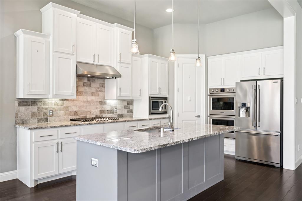 3415 Secretariat Place Celina, TX 75009 - Photo 2 of 40 a kitchen with stainless steel appliances granite countertop a sink a stove a refrigerator a counter space and cabinets