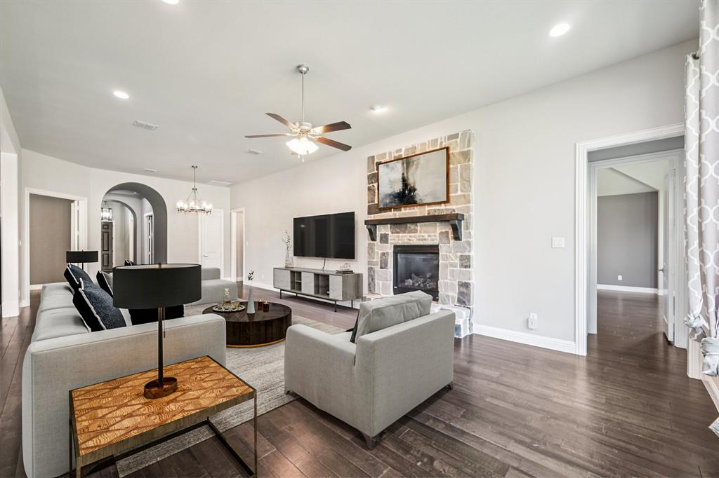 3415 Secretariat Place Celina, TX 75009 - Photo 24 of 40 a living room with furniture a fireplace and a flat screen tv