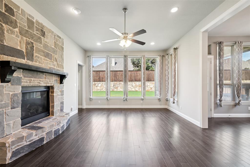 3415 Secretariat Place Celina, TX 75009 - Photo 26 of 40 a view of an empty room with wooden floor fireplace and a window
