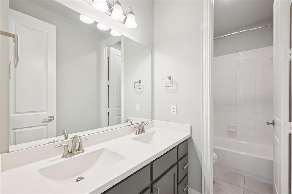 3415 Secretariat Place Celina, TX 75009 - Photo 34 of 40 a bathroom with a sink a tub and a mirror