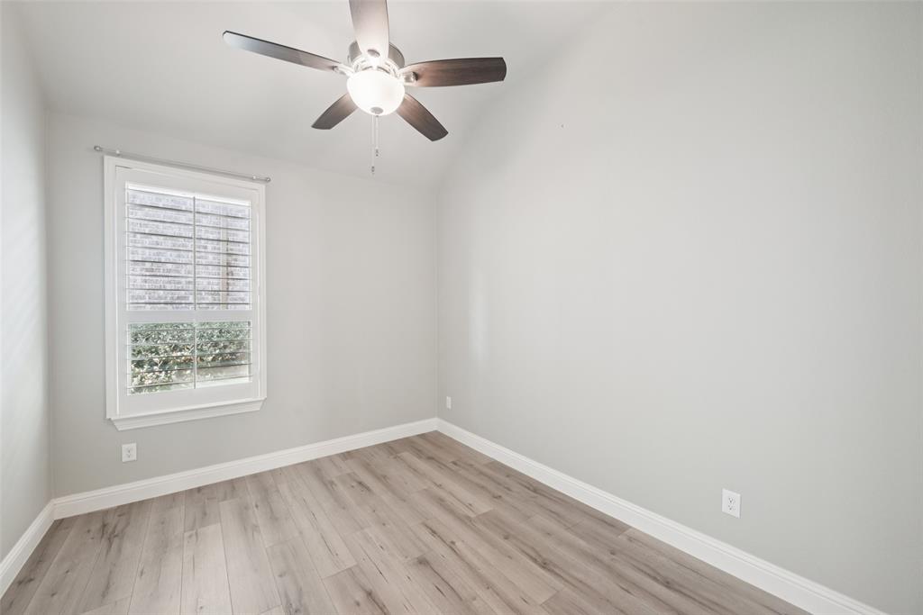 3415 Secretariat Place Celina, TX 75009 - Photo 38 of 40 an empty room with wooden floor fan and windows