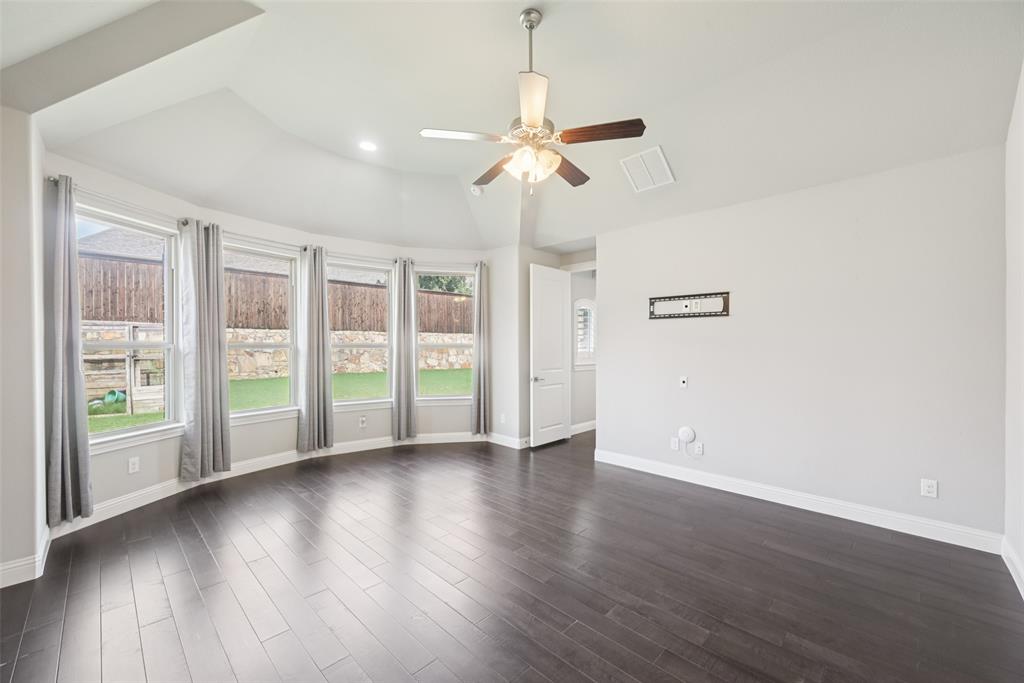 3415 Secretariat Place Celina, TX 75009 - Photo 40 of 40 a view of an empty room with wooden floor and a window